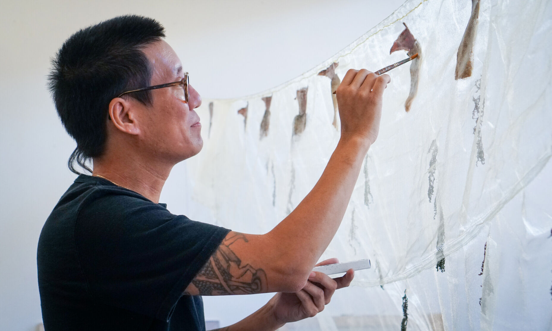 A man paints in his studio